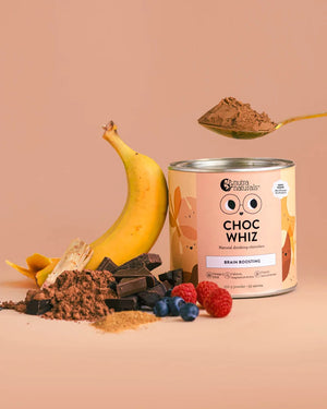 Can of 'Choc Whiz' with chocolate powder, banana, and berries on a beige background